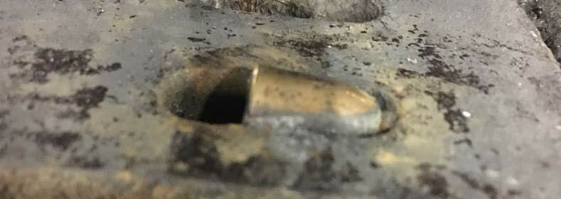 Idle Hands - A bullet in a drainage grate near IKEA