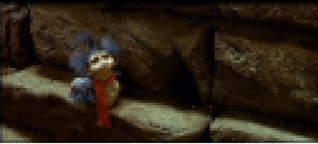 The Worm from Labyrinth, tiny and friendly, poking out of a brick wall